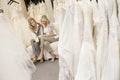 Mother and daughter looking at footwear in bridal store