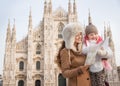 Mother and daughter looking on map while standing near Duomo Royalty Free Stock Photo