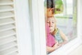 Mother and daughter looking through the window Royalty Free Stock Photo