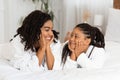 Mother Daughter Love. Black Girl And Mom Lying On Bed In Bathrobes Royalty Free Stock Photo