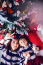 Mother and daughter lying under the Christmas tree Royalty Free Stock Photo