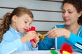 Mother and daughter make artificial roses Royalty Free Stock Photo