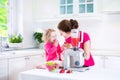 Mother and daughter making fruit juice Royalty Free Stock Photo