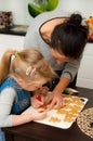 Mother and daughter making gingerbread cookies at home Royalty Free Stock Photo
