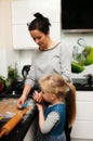 Mother and daughter making gingerbread cookies at home Royalty Free Stock Photo