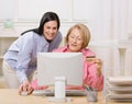 Mother and daughter making online purchase