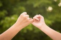 Mother and daughter making a pinkie promise