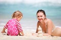 Mother and daughter making sand castle