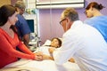 Mother And Daughter With Medical Staff In Hospital Room Royalty Free Stock Photo