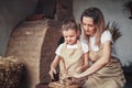 Mother and daughter mold with clay, enjoying pottery art and production process. Making ceramic dishes