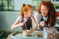 Mother and daughter mold with clay on pottery