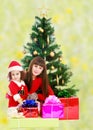 Mother with daughter near the Christmas tree Royalty Free Stock Photo