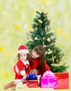 Mother with daughter near the Christmas tree Royalty Free Stock Photo