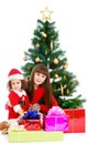 Mother with daughter near the Christmas tree Royalty Free Stock Photo