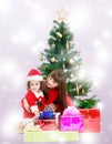 Mother with daughter near the Christmas tree Royalty Free Stock Photo