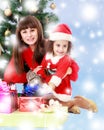 Mother with daughter near the Christmas tree Royalty Free Stock Photo