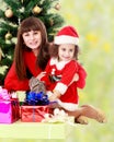 Mother with daughter near the Christmas tree Royalty Free Stock Photo