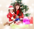 Mother with daughter near the Christmas tree Royalty Free Stock Photo