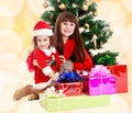 Mother with daughter near the Christmas tree Royalty Free Stock Photo