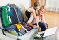 Mother with daughter near suitcase with credit card