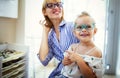 Mother and daughter in optician shop buying eyeglasses Royalty Free Stock Photo