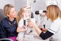 Mother and daughter in optometrist office checking vision