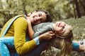 Mother and daughter outdoors in a meadow. Little girl lying on m Royalty Free Stock Photo