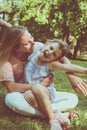 Mother and daughter outdoors in a meadow. Mother and daughter si Royalty Free Stock Photo