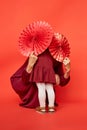 Mother and daughter with paper fans hiding Royalty Free Stock Photo