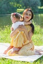 Mother and daughter in the Park by the lake. A girl embraces a woman