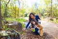 Mother daughter in a park picking clover plants