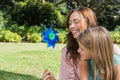 Mother with daughter with a pinwheel in the park Royalty Free Stock Photo