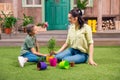 Mother and daughter with plants and flowerpots