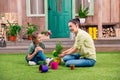 Mother and daughter with plants and flowerpots