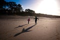 Mother and daughter play on beach