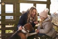 Mother and daughter play with dog in countryside, close up Royalty Free Stock Photo