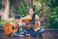 Mother with daughter play guitar. Family spending time together Royalty Free Stock Photo