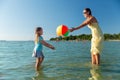 Mother and daughter playing with ball on beach Royalty Free Stock Photo