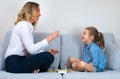 Mother and daughter playing board game.