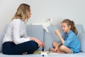 Mother and daughter playing board game.