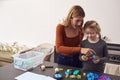 Mother With Daughter Playing With Engineering Construction Kit Together At Home Royalty Free Stock Photo