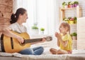 Mother and daughter playing guitar Royalty Free Stock Photo