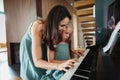 Mother and daughter playing on piano together. Royalty Free Stock Photo