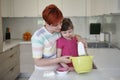 Mother and daughter playing and preparing dough in the kitchen Royalty Free Stock Photo