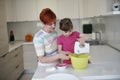 Mother and daughter playing and preparing dough in the kitchen Royalty Free Stock Photo