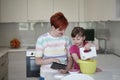 Mother and daughter playing and preparing dough in the kitchen Royalty Free Stock Photo