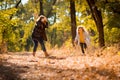 Mother and daughter playing and running in autumn Park. fun family nature walks