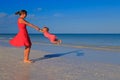 Mother and daughter playing on summer beach Royalty Free Stock Photo