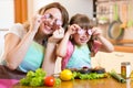 Mother and daughter playing with vegetables in Royalty Free Stock Photo