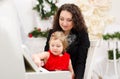 Mother and daughter playing on white piano Royalty Free Stock Photo